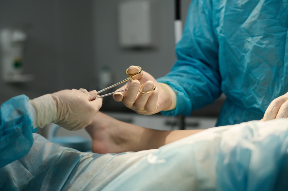 Surgeons passing surgical scissors during an operation