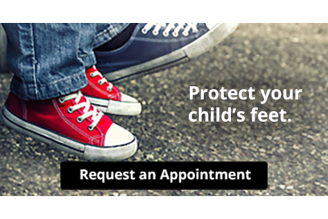 Child wearing red sneakers standing next to adult