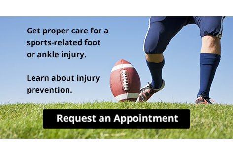 Football player kicking ball on grass field