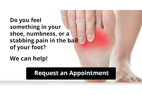 Hand touching painful red area on ball of foot