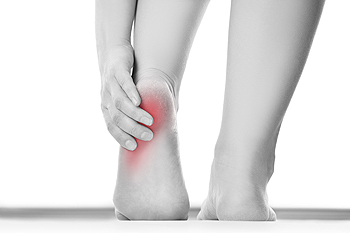 Person holding painful heel with red pain indicator