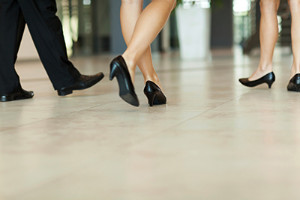 Business professionals walking in black dress shoes on floor