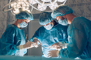 Three surgeons performing an operation in an operating room