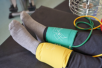 Blood pressure cuffs on patient's legs during medical exam